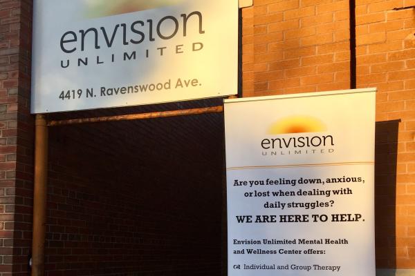 A doorway is depicted with signage from Envision Unlimited