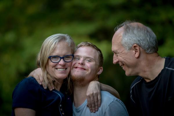 A group of people is seen laughing and embracing each other