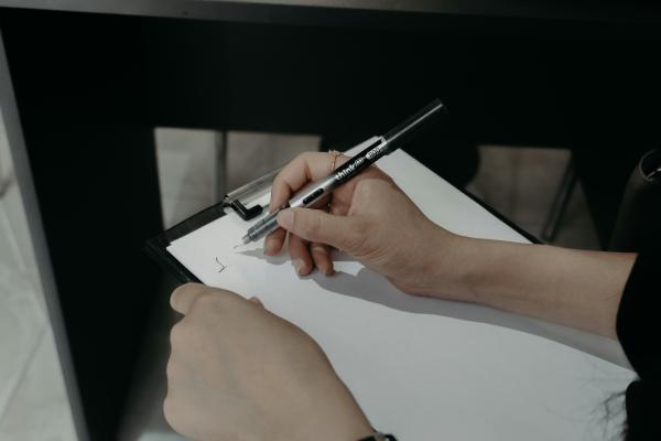A person writing on a clipboard.