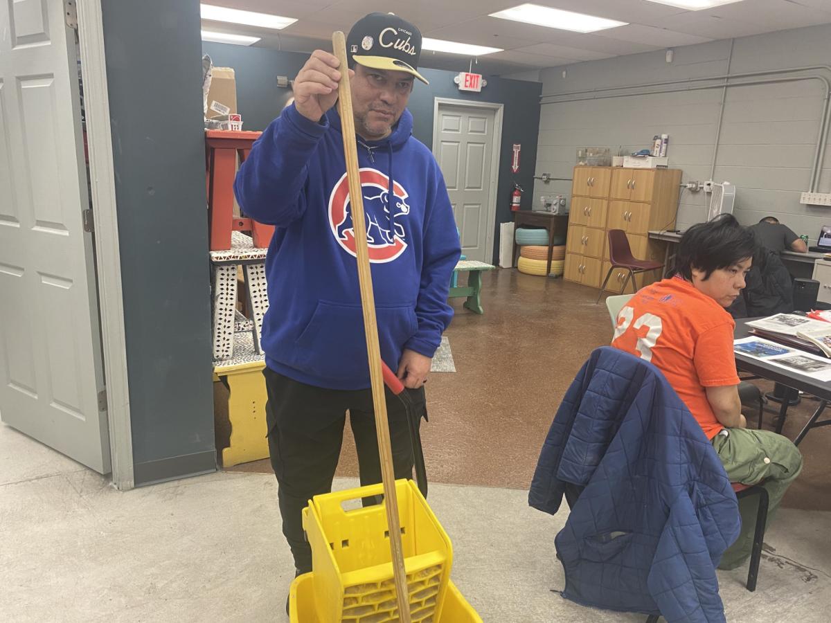 Robert Soto mopping the floor