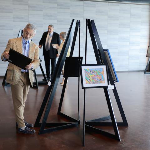 A gala attendee browses the 2026 Bright Futures Ball ArtWalk