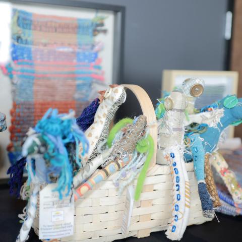 A collection of woven art from members is displayed
