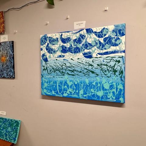 Paintings hanging on a wall.