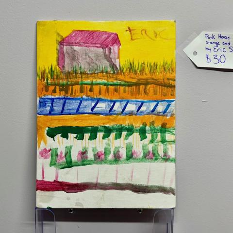 A painting that includes a pink house, green grass and an orange and yellow background.