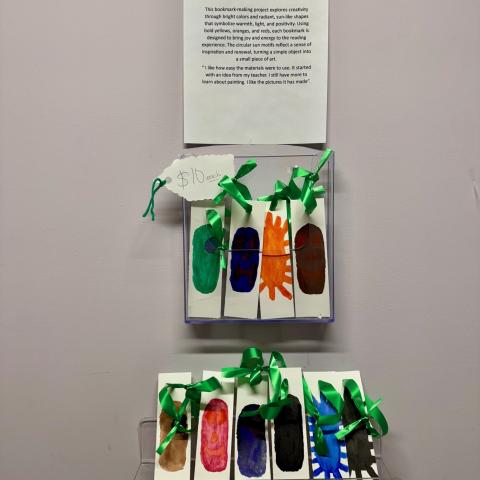 A group of handmade bookmarks displayed on a wall.