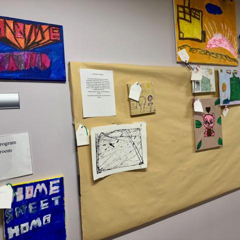 A group of paintings on a wall.