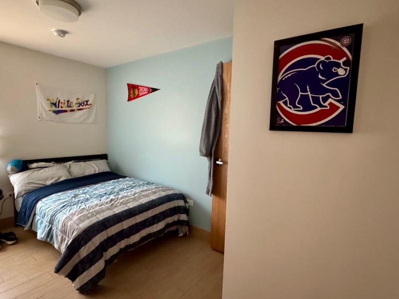 A bedroom is pictured decorated with Chicago sports memorabilia