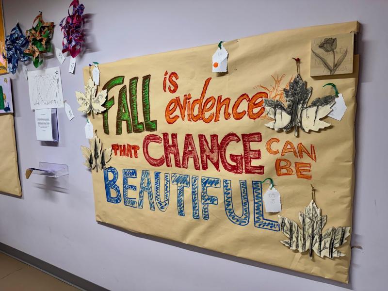 An art project with the words "Fall is evidence change can be beautiful" is pictured as part of a mental health art show display