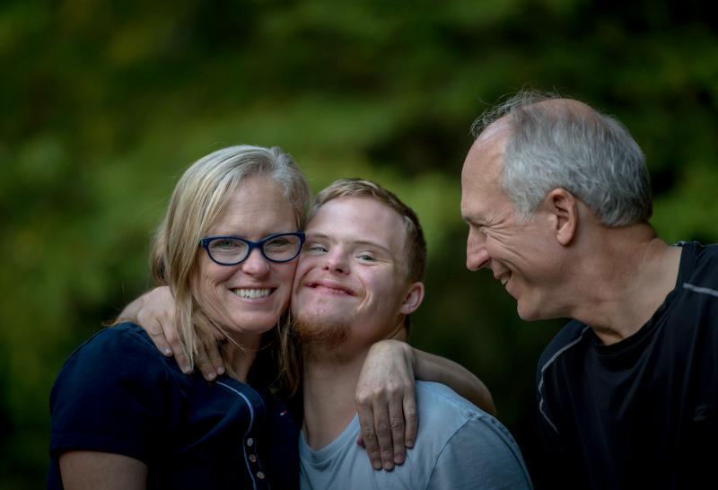 A group of people is seen laughing and embracing each other