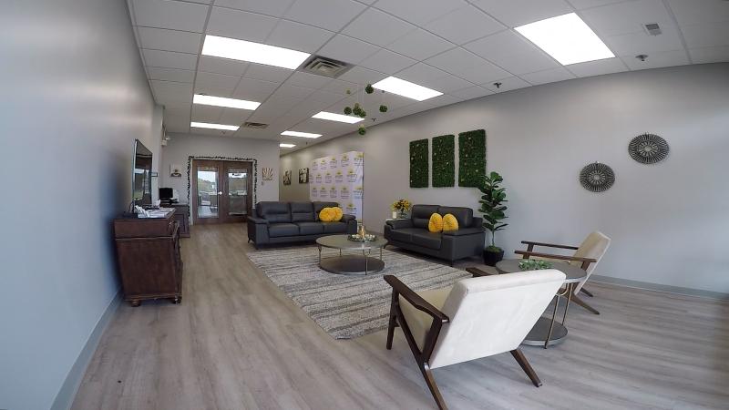 A room is pictured with couches, chairs, and a relaxing ambience